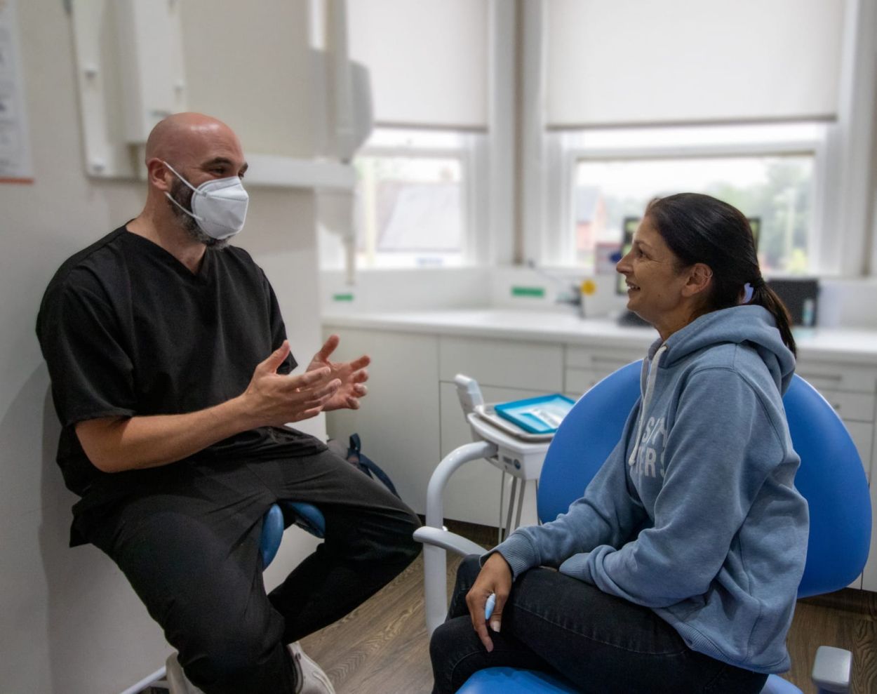 Dentist talking with a patient in the treatment room